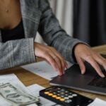 Salary Negotiations - A Woman in Plaid Blazer Using Her Laptop