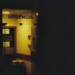 Urgency - A black and white photo of a door with a light on it